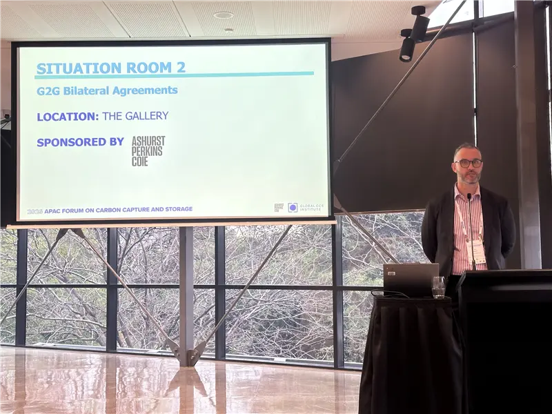 A speaker presenting a scenario involving bilateral agreements for cross-border carbon dioxide transport